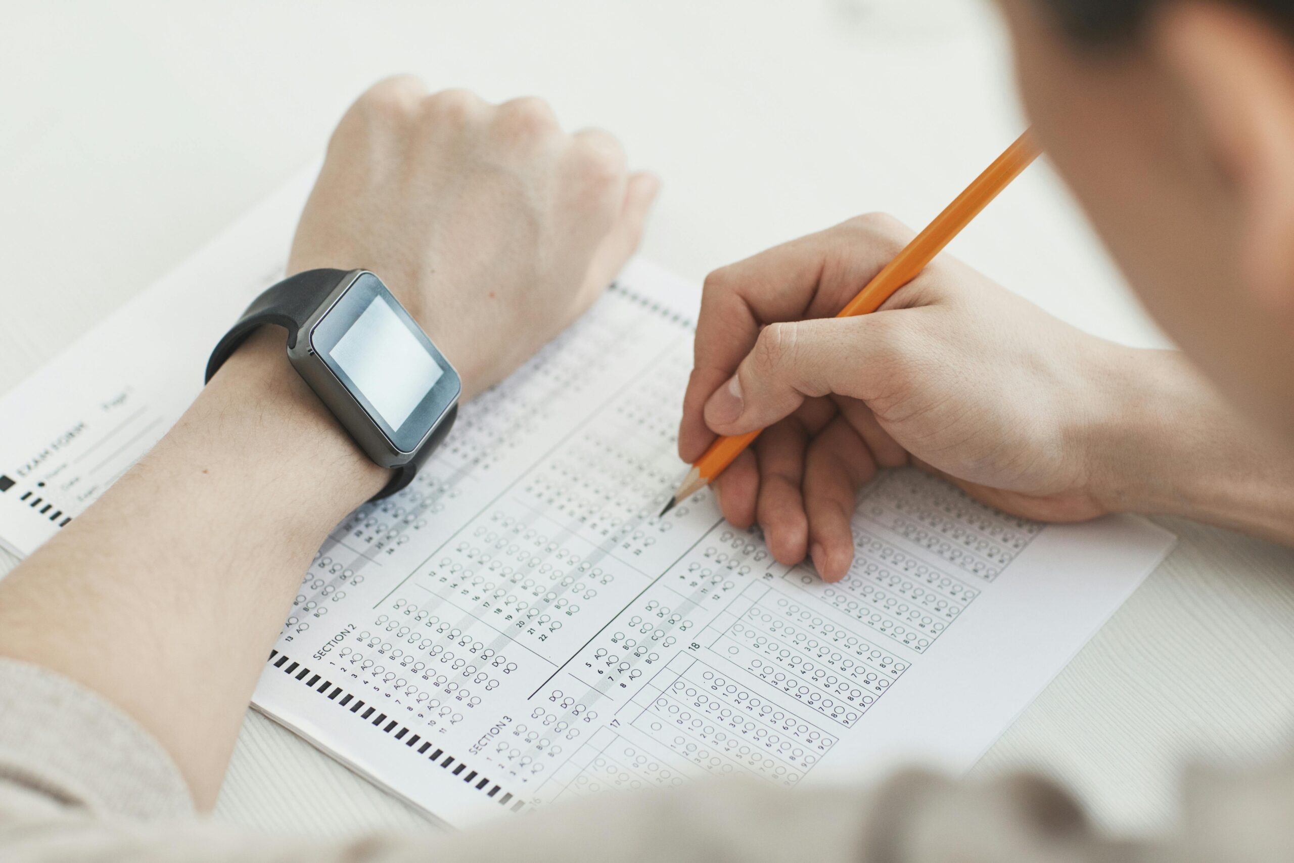 Student wearing a sleek watch calculator confidently taking a standardized test.