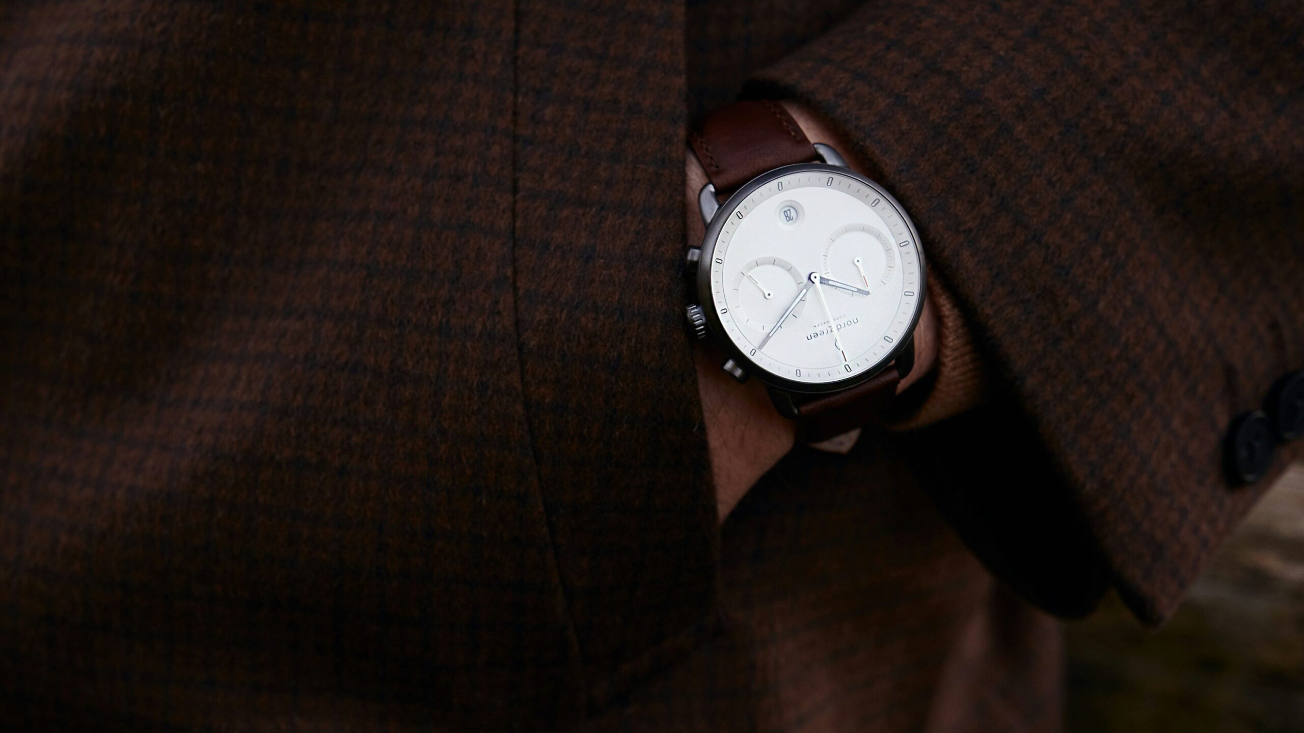 Close-up shot of futuristic wearables including a watch featuring a test calculator interface