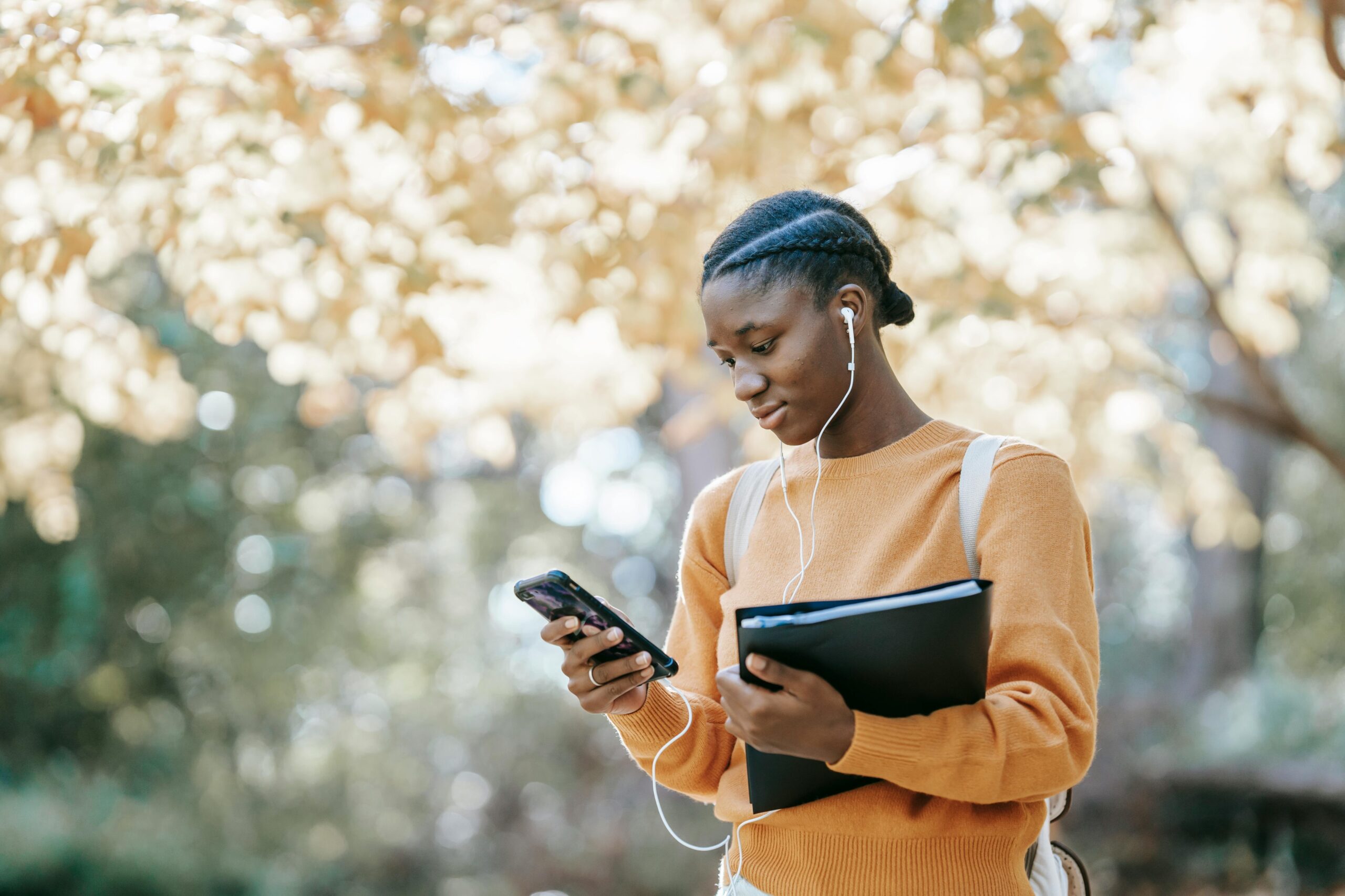 College student wearing Garmin watch while solving equations through mobile app