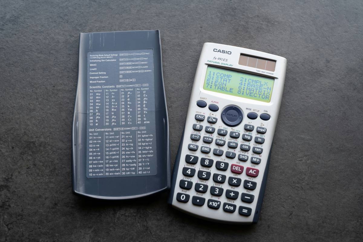 A student happily using a watch calculator during a study session