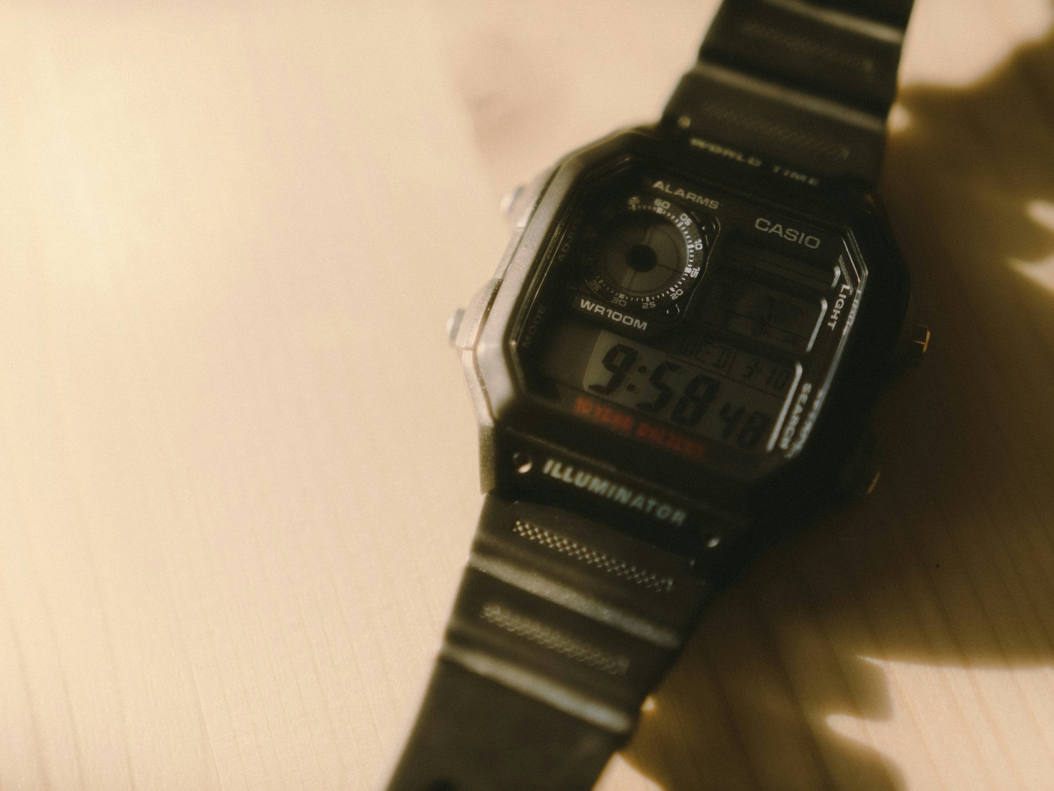 A student wearing a sleek black school watch with a digital display.