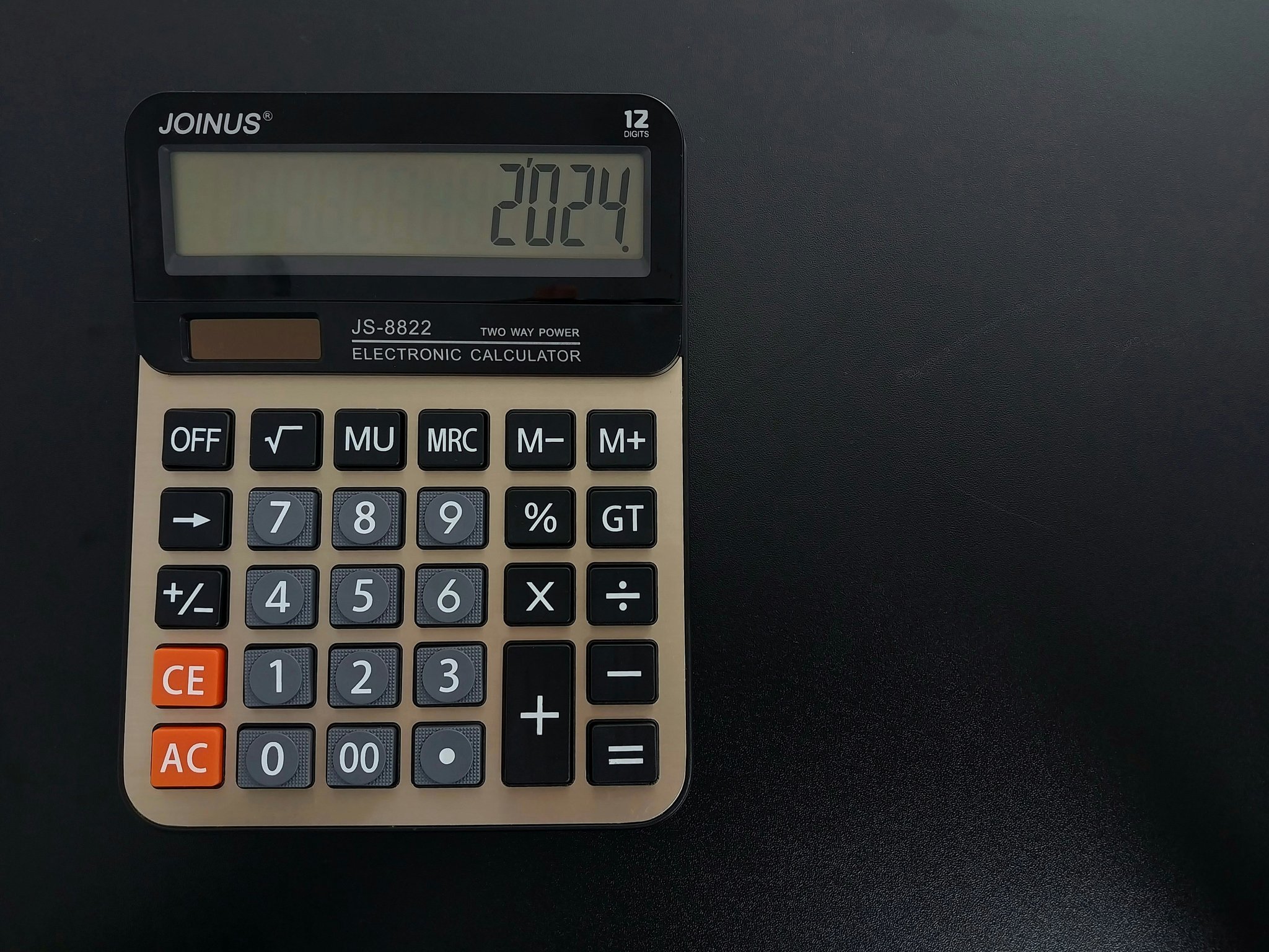 Close-up shot of a modern watch calculator showing its digital display and buttons.