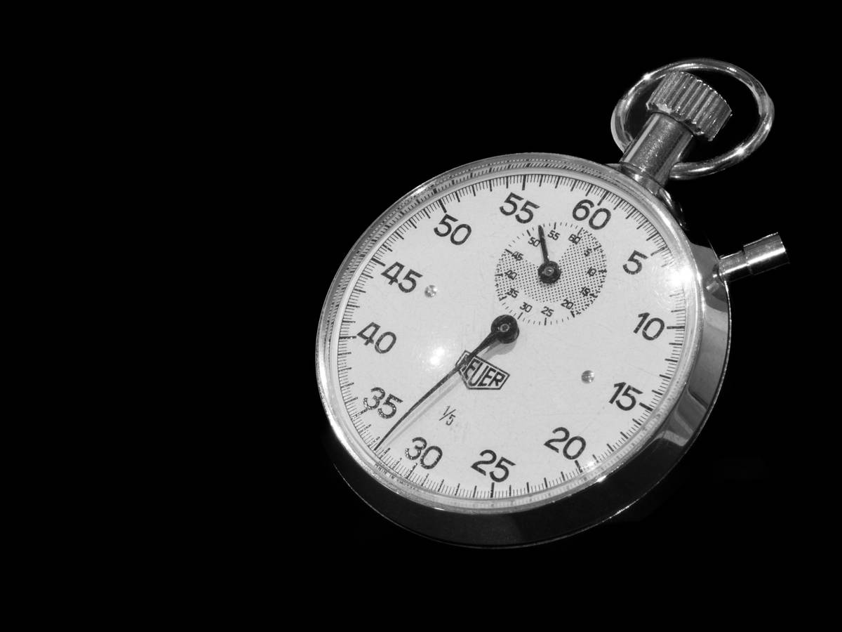 Close-up shot of a sleek watch calculator with labeled buttons