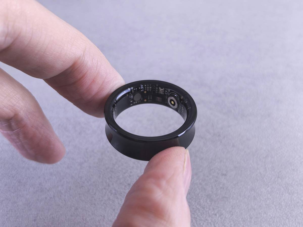 Person cleaning a calculator watch with a microfiber cloth