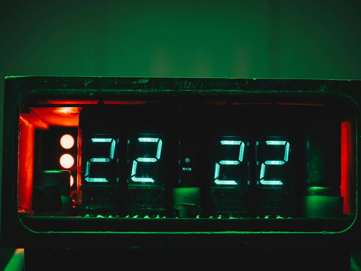 Photo of Sarah holding her favorite watch calculator while working remotely.