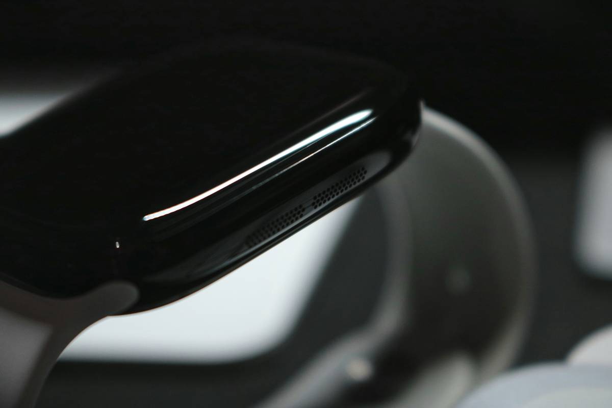 A close-up shot of a sleek, futuristic prep calc watch with LED display and tactile buttons.