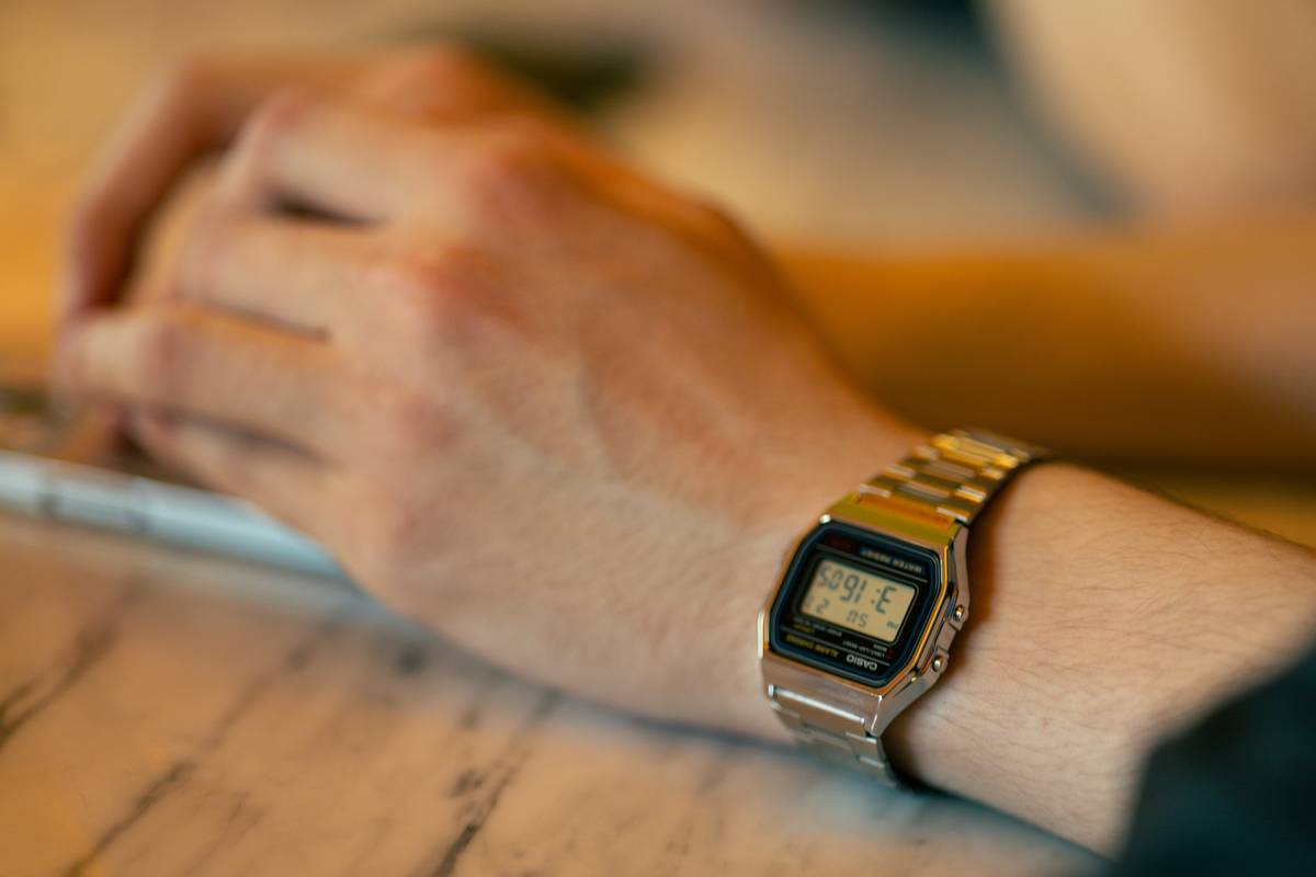 A close-up image of a modern watch calculator showing buttons and a digital display.