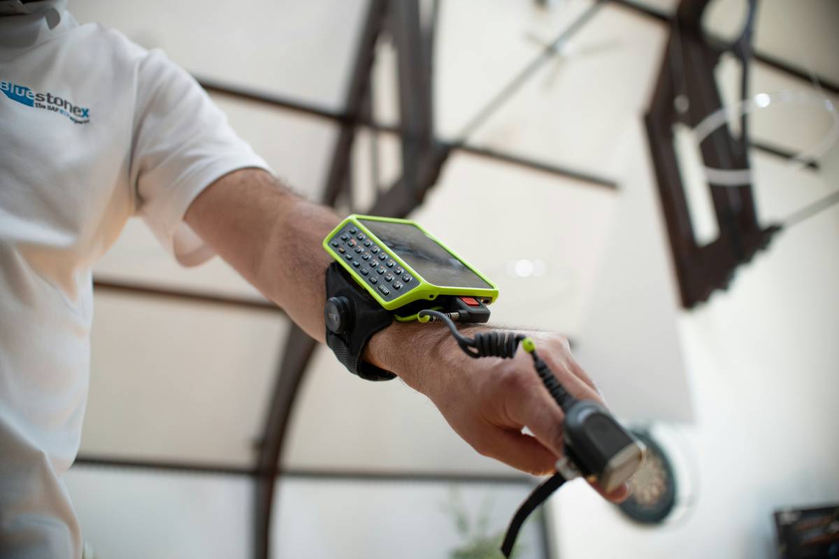 Smartwatch displaying scientific calculator watch face with unit conversion overlay during outdoor construction task
