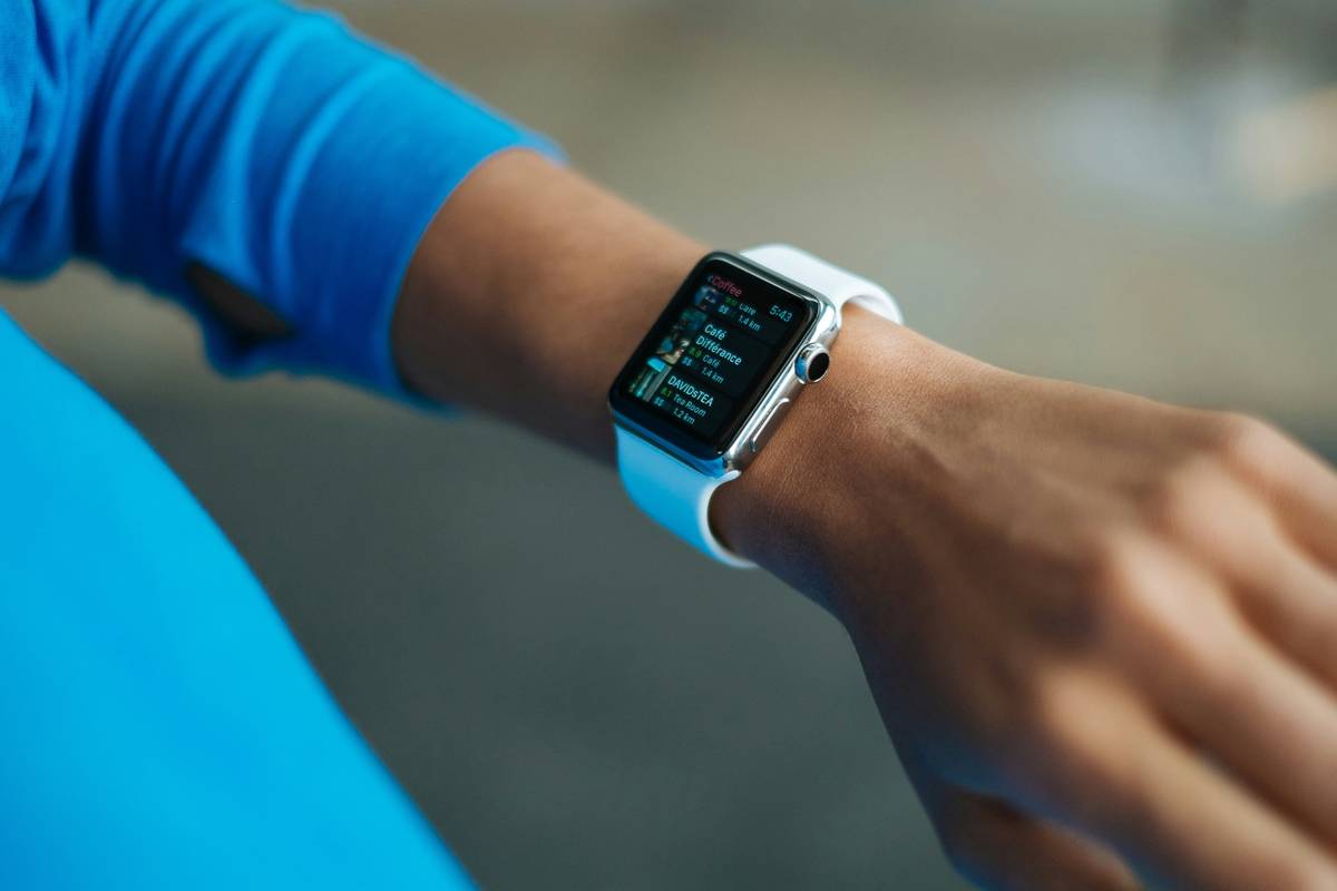 Smartwatch displaying an algebra calculator that shows work with step-by-step solution to 2x + 5 = 13